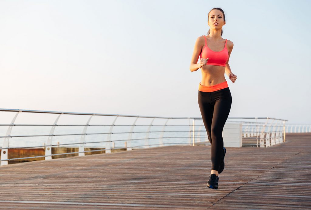 beautiful-young-sportswoman-training-and-running-on-pier-in-the-morning